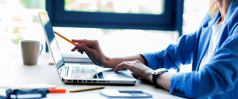 a woman in her office working on her laptop, depicting affiliates and working on affiliate business programs